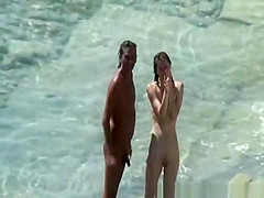 Nudist couple sunbathing and refreshing