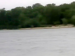Naked girl playing frisbee on a beach