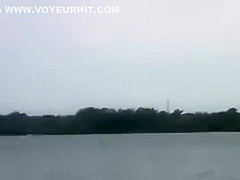 Naked girl playing frisbee on a beach