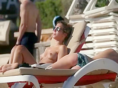 Playful couple spied on the beach