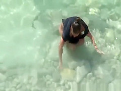 Nudist woman spied in rocky beach