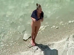 Nudist woman spied in rocky beach