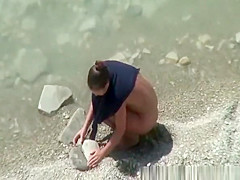 Nudist woman spied in rocky beach