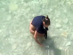 Nudist woman spied in rocky beach