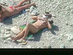 Nudist chick and friends in beach