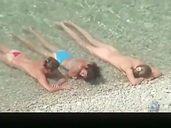 Nudist chick and friends in beach