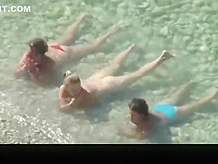 Nudist chick and friends in beach