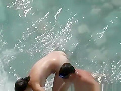 Nudist couple in the water