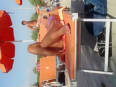 Milf lying by the pool and touching pussy