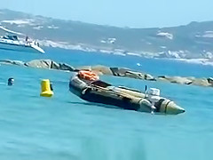 Topless women puts sun cream on face