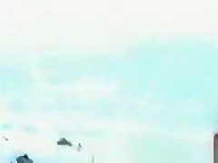 Topless women puts sun cream on face