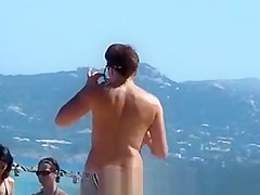 Topless women puts sun cream on face