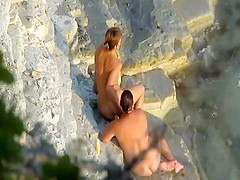 Romantic masturbation on a rocky beach