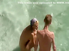 Peeping as he fingers her on a beach