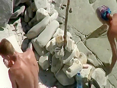 Peeping as he fingers her on a beach