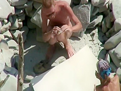 Peeping as he fingers her on a beach