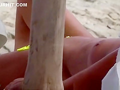 The old woman is walking topless on the beach