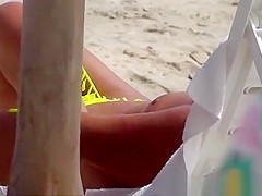 The old woman is walking topless on the beach