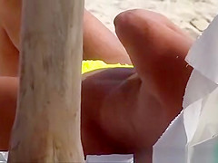 The old woman is walking topless on the beach