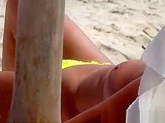 The old woman is walking topless on the beach