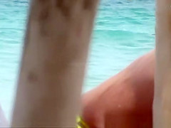 The old woman is walking topless on the beach
