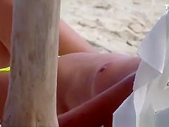 The old woman is walking topless on the beach