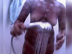 Naked redhead reads on the beach