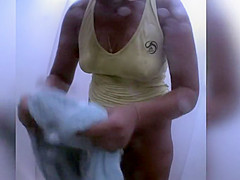 Naked redhead reads on the beach