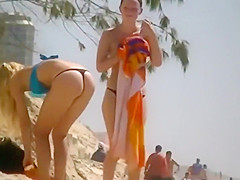 Girl in a thong bikini bending over