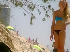 Girl in a thong bikini bending over