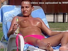 Topless girl smokes and drinks