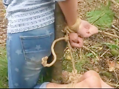 Bastinado foot torture in the forest