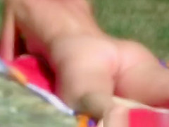 Nude women on grassy beach in lake forest