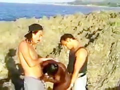 African hairy girl and 2 guys on the rocks