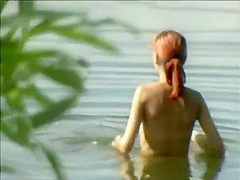 Teen girl spied as she swims in a lake