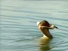 Teen girl spied as she swims in a lake