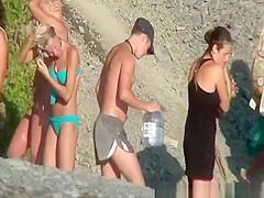 Nudist bathing by waterfall