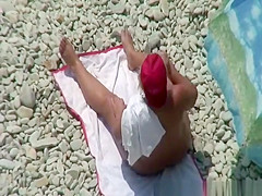Chubby mature nudist woman with red cap