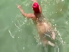 Chubby mature nudist woman with red cap