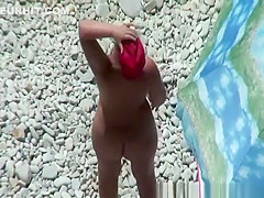 Chubby mature nudist woman with red cap