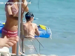 Mature topless woman spied on a beach