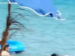 Mature topless woman spied on a beach