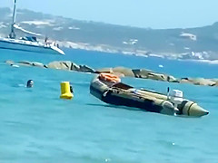 Mature topless woman spied on a beach