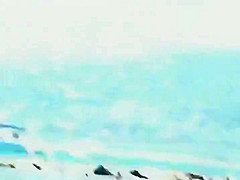 Mature topless woman spied on a beach