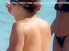 Mature topless woman spied on a beach