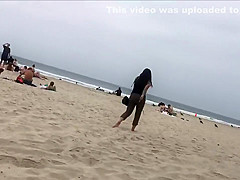 Fit blonde exercises on beach