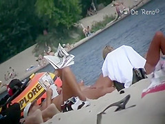 Nude woman with pony tail sunbathing