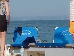 Girl on the beach dresses pants.