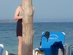 Girl on the beach dresses pants.