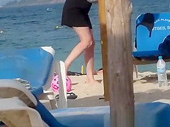 Girl on the beach dresses pants.